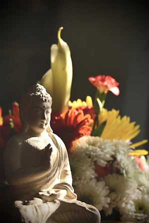 A peaceful corner of the hall decorated with simple Buddhist art and fresh flowers.