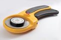 a yellow and black tool on a white surface