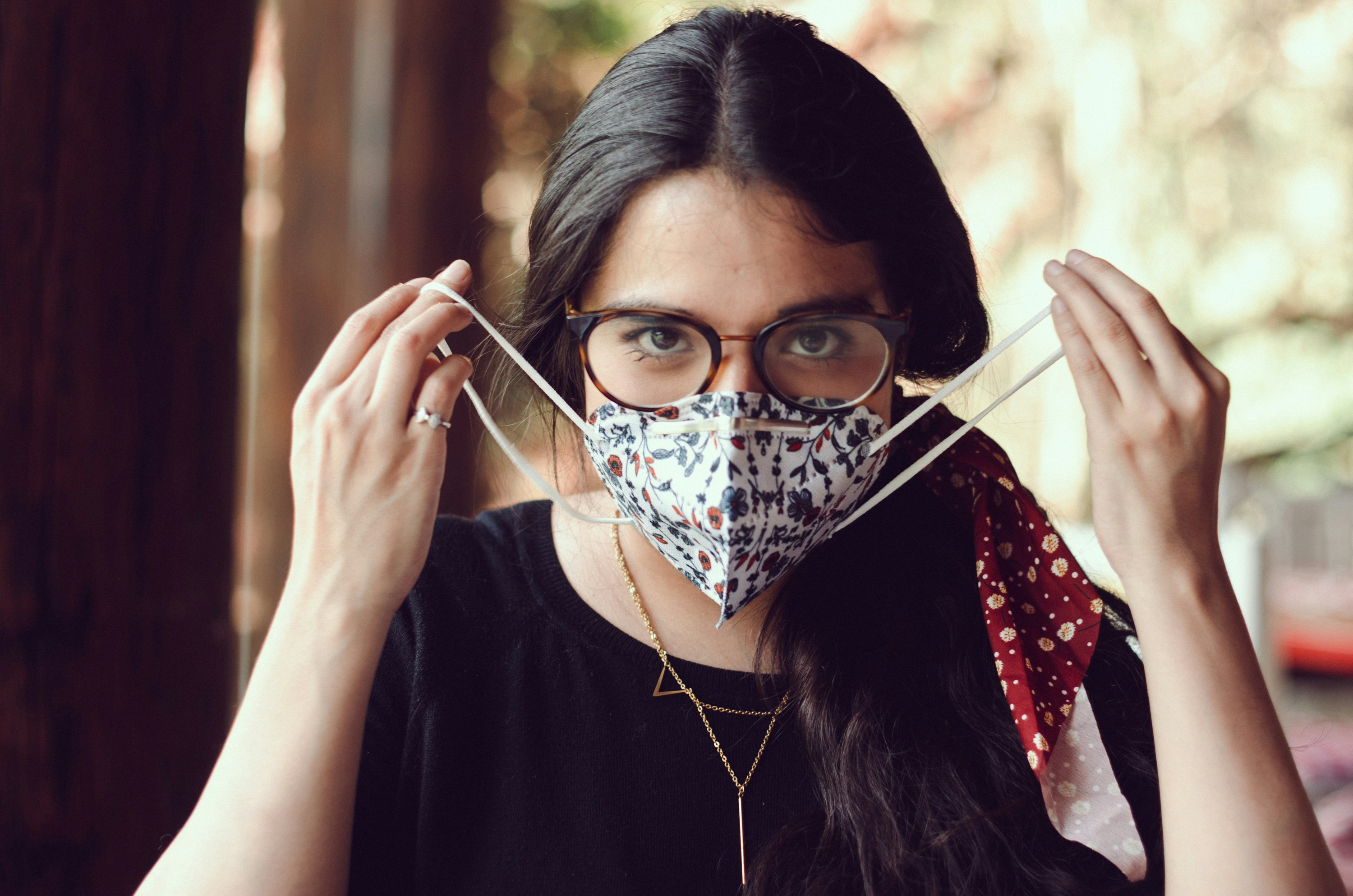 a woman wearing a face mask and glasses