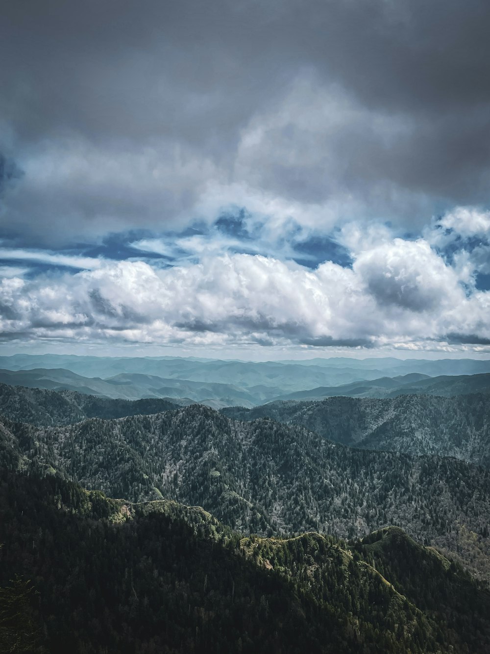 a view of a mountain range under a cloudy sky