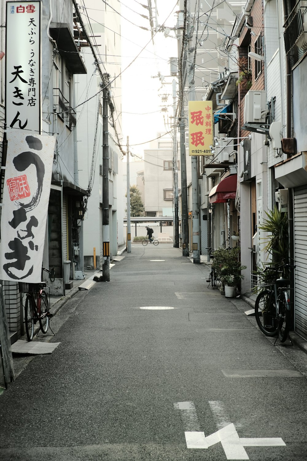 an empty street with a bike parked on the side of it