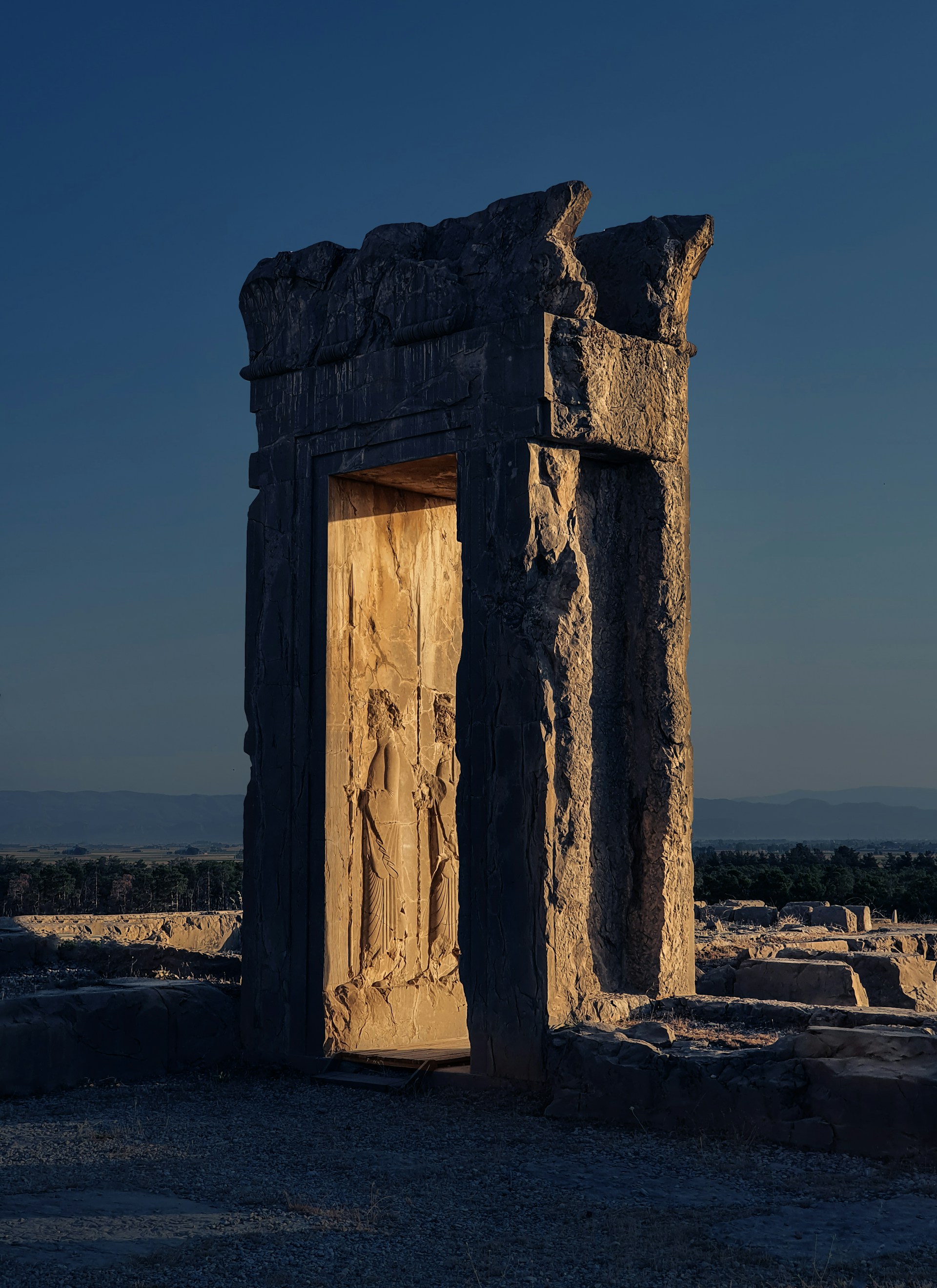a stone structure with a door and carvings on it