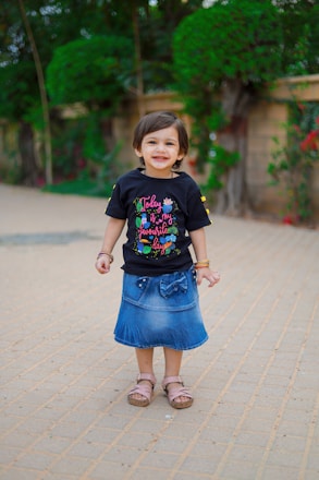 Young girl happily walking outdoors wearing colorful synthetic shoes.