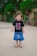A happy child wearing Kiddie Crew streetwear in a park.