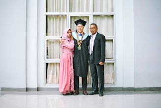 a couple of people that are standing in front of a window