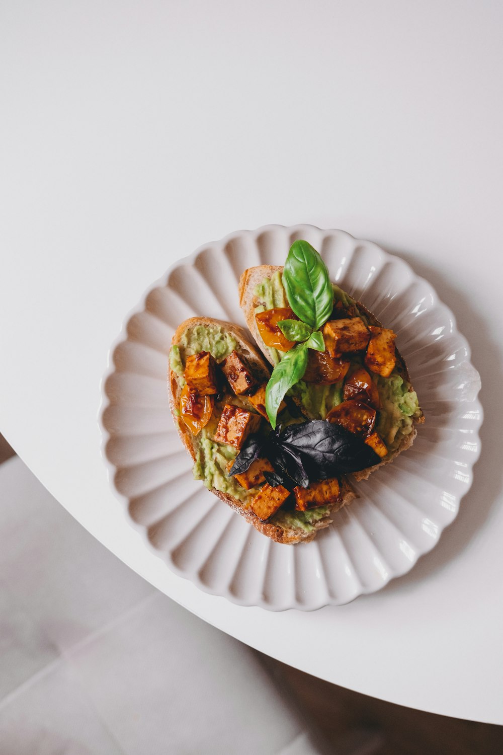 a white plate topped with food on top of a table