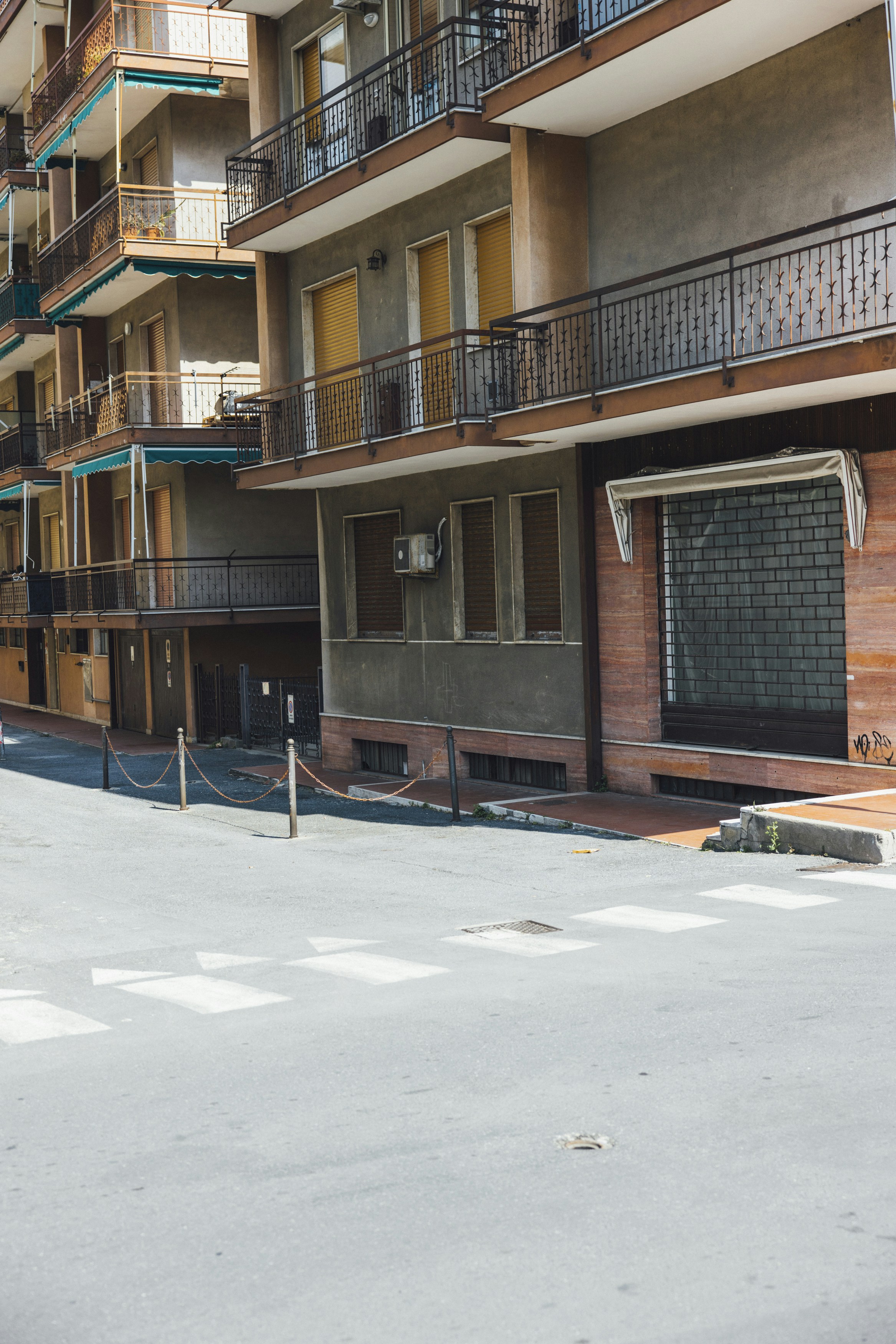 an empty parking lot in front of a building with balconies