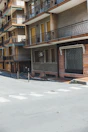 View of the apartment building’s charming facade in a quiet street.