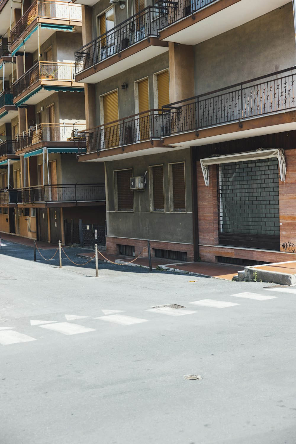 an empty parking lot in front of a building with balconies