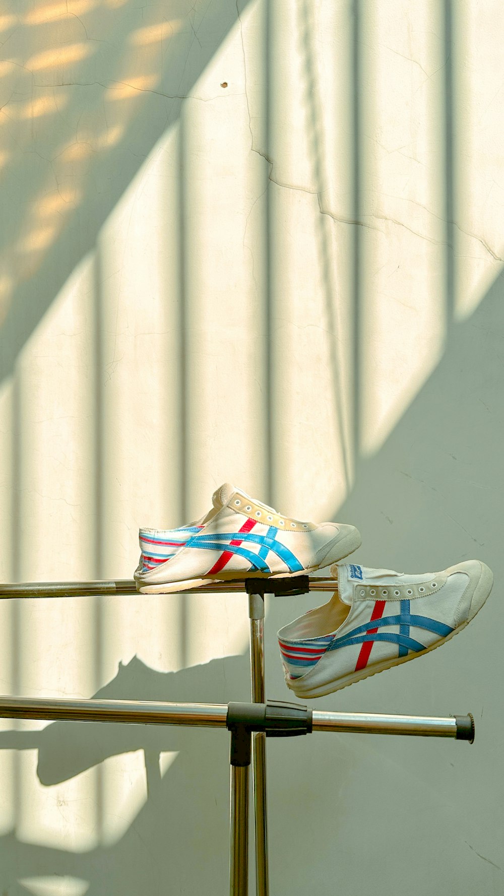 a pair of shoes sitting on top of a metal pole