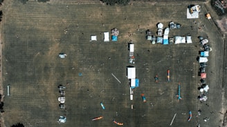 Aerial view of multiple temporary structures arranged neatly for a large festival.