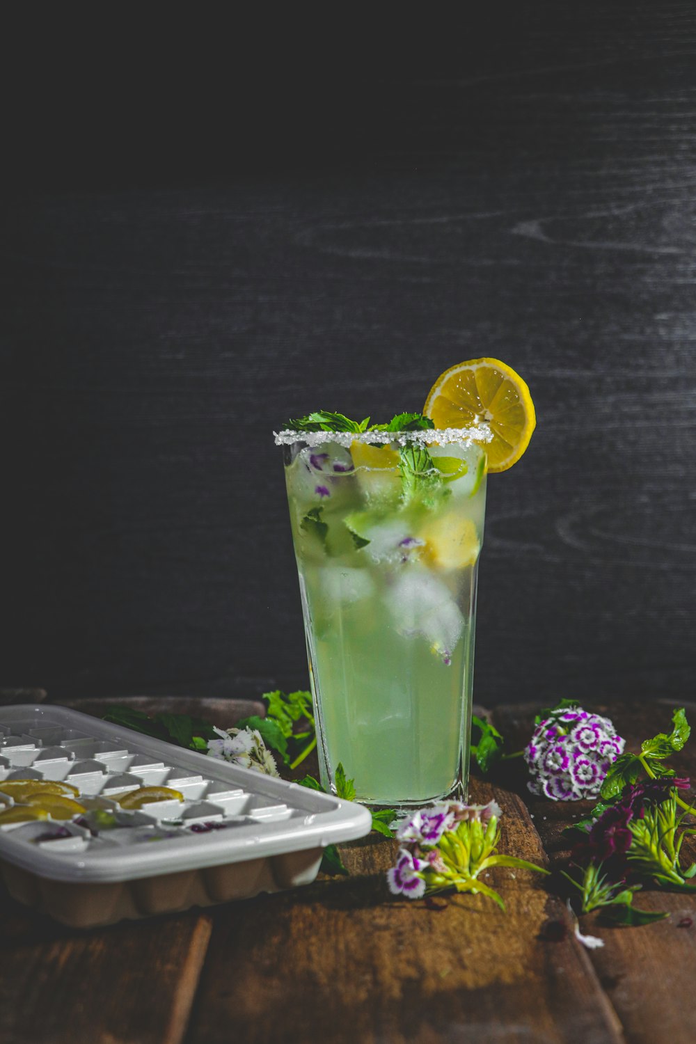 a tall glass filled with a green drink