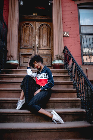 a woman sitting on the steps of a building