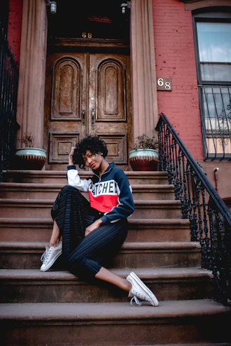 a woman sitting on the steps of a building