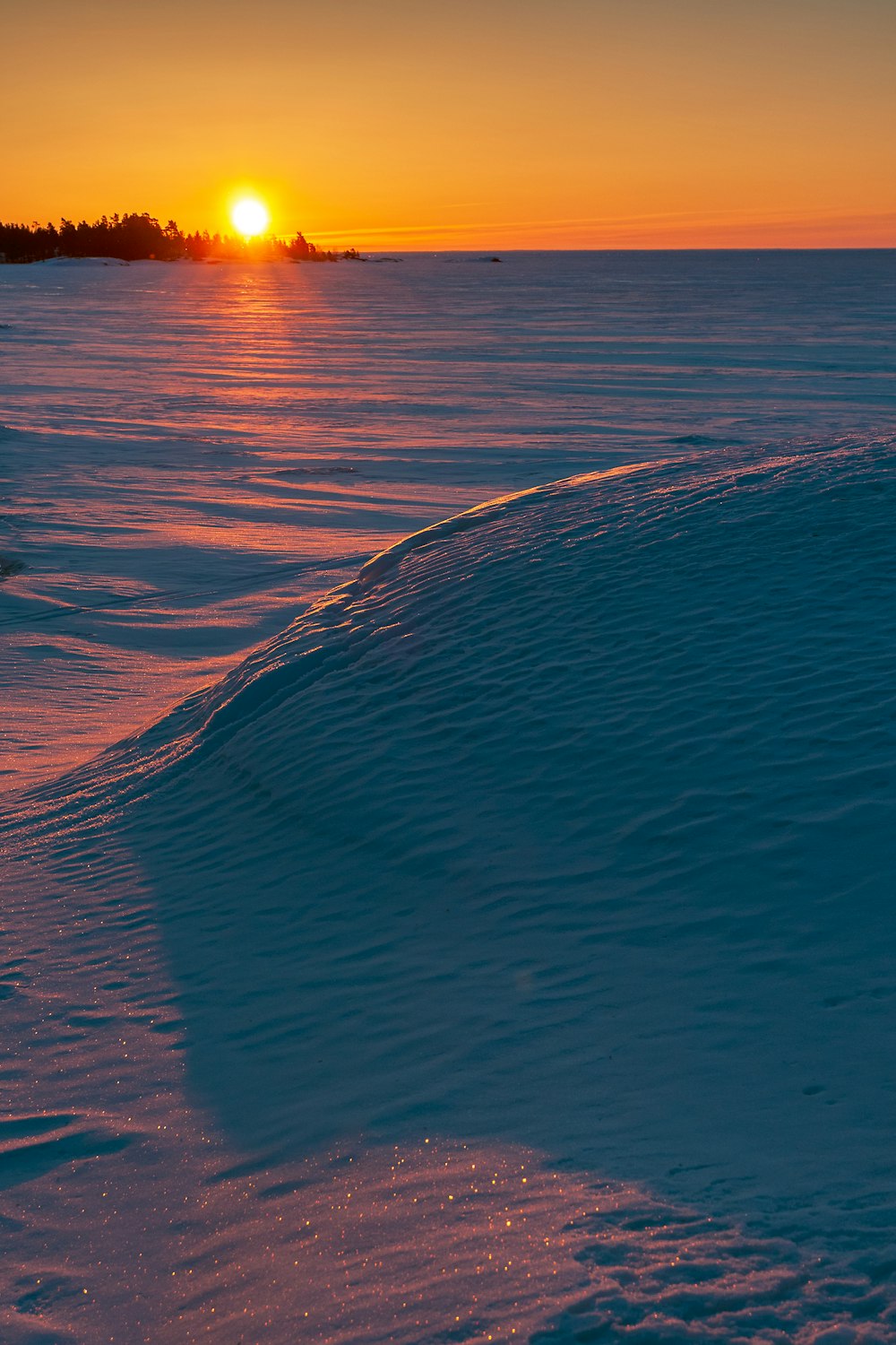 the sun is setting over the horizon of the ocean