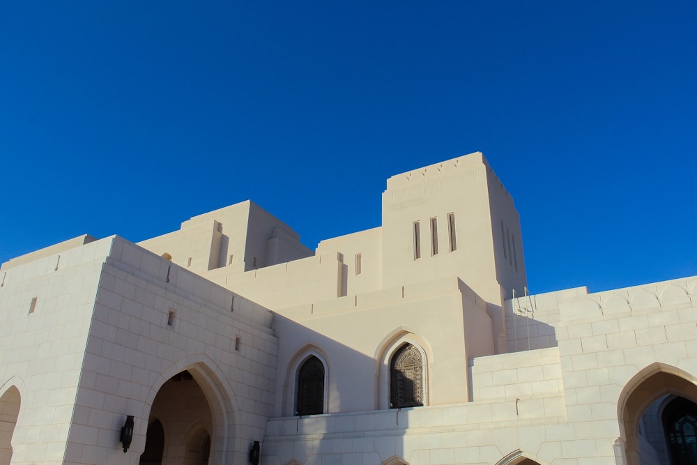 a large white building with a clock on it's side