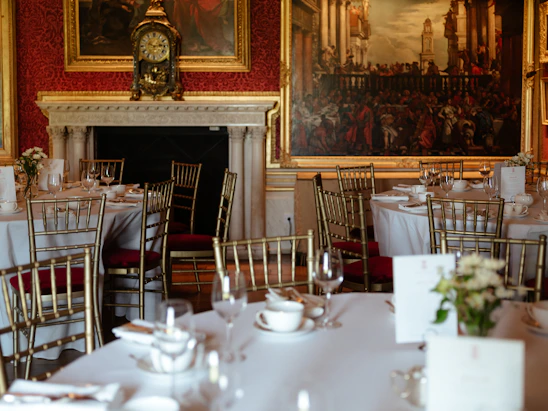 A warm, inviting view of the historic Coin Harvey House dining room set for an elegant catered event.
