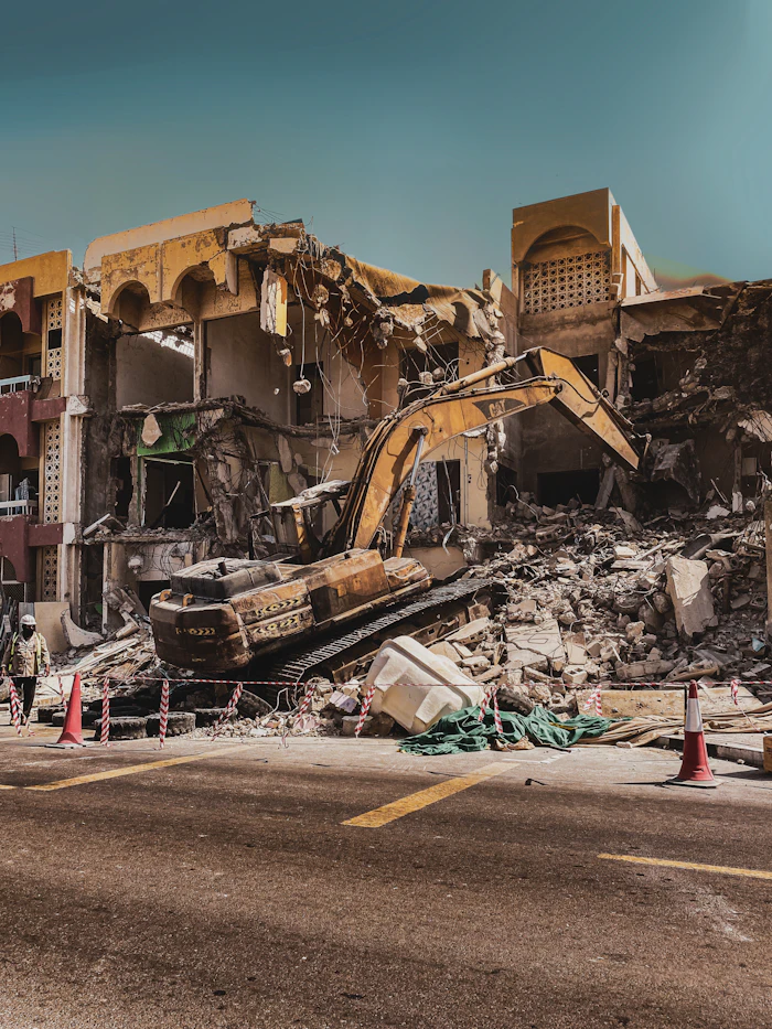 Demolished building with excavator in the foreground