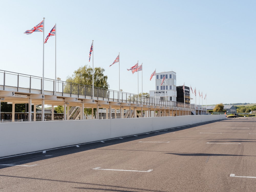 an empty parking lot with flags flying in the wind