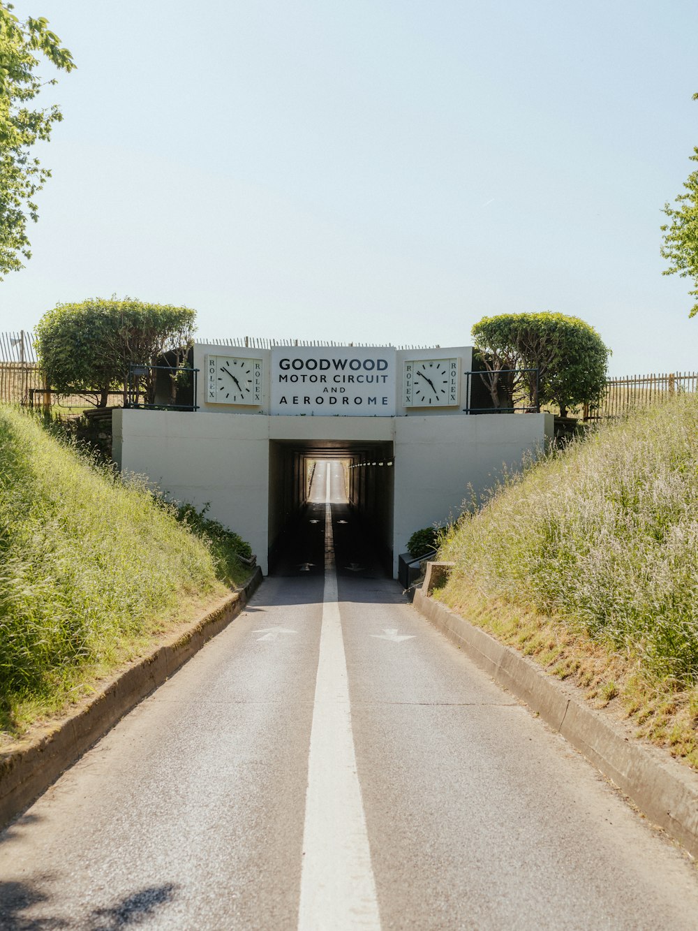 a road going into a tunnel with a sign on it