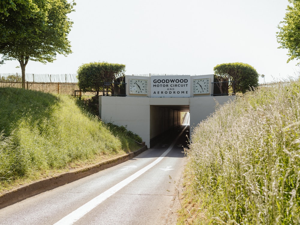a road going into a tunnel with a sign on it
