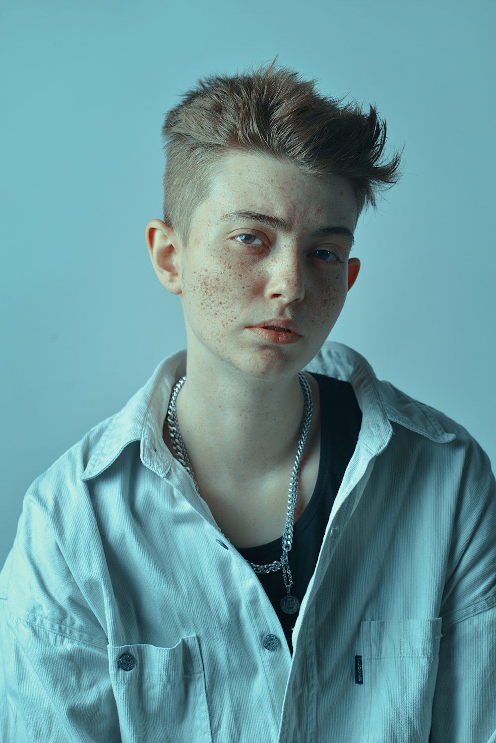 a young man with freckles on his face