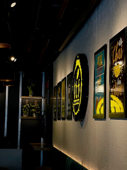 A cozy corner with The Bitz 420 logo framed on the wall and ambient lighting