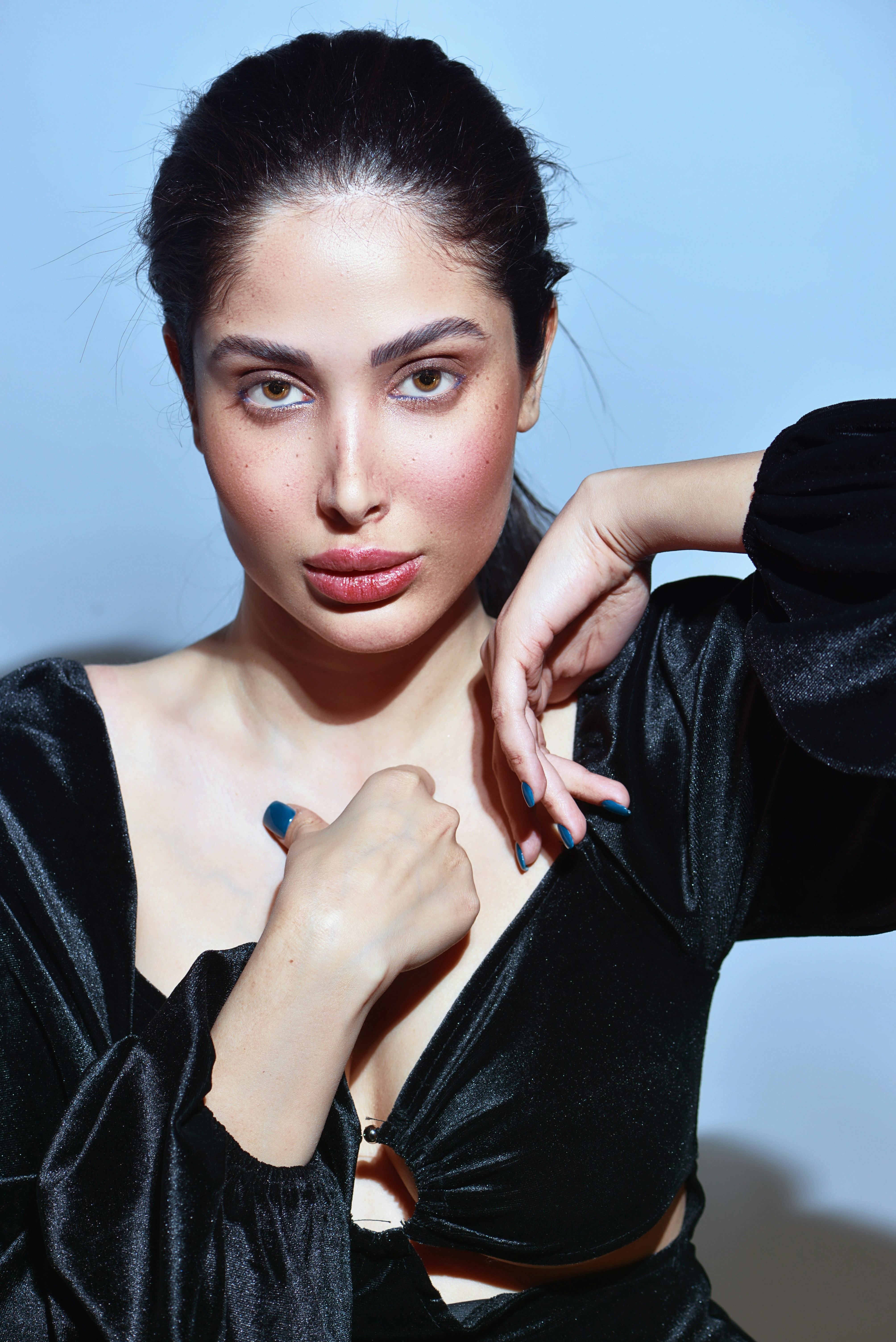 a woman in a black dress posing for a picture