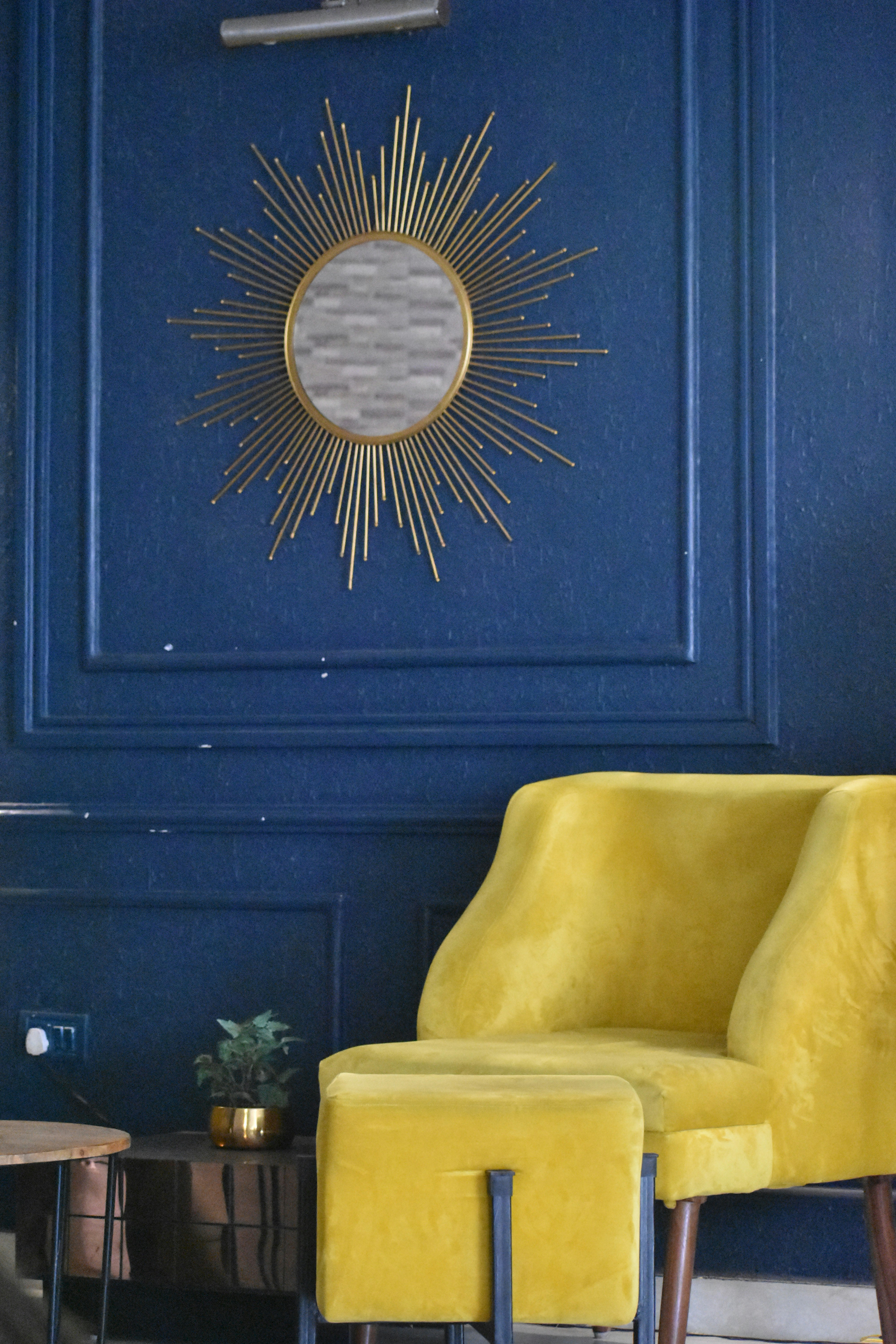 A living room with blue walls and a yellow chair photo – Free Interior ...