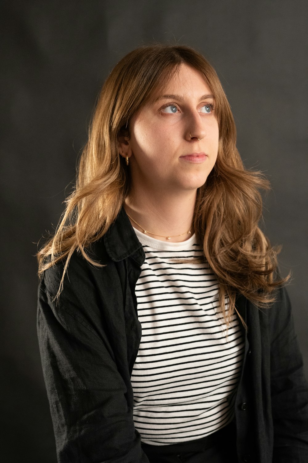 a woman with long hair and a striped shirt