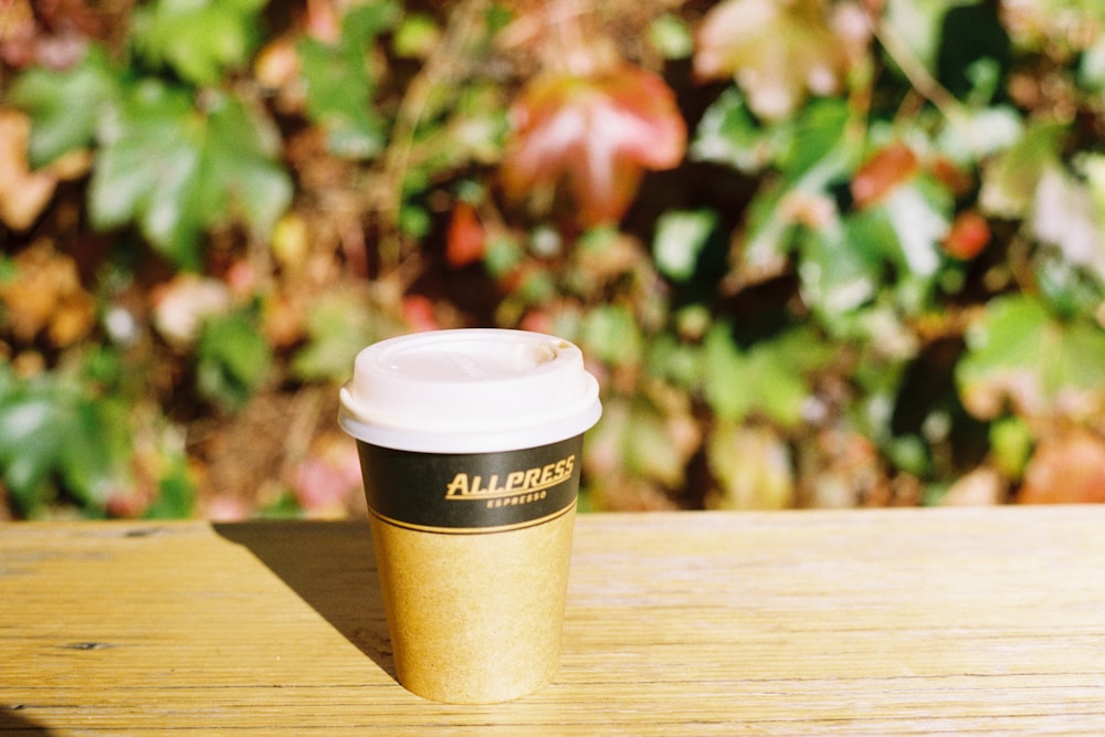 a coffee cup sitting on top of a wooden table