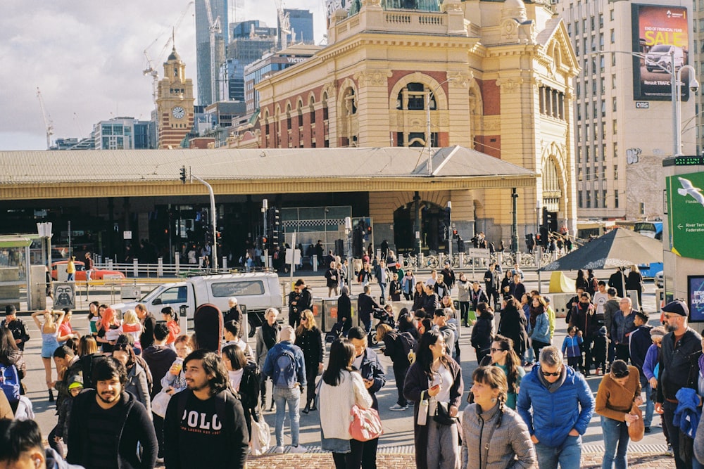 a large group of people walking around a city