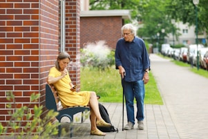 a woman sitting on a bench next to a man