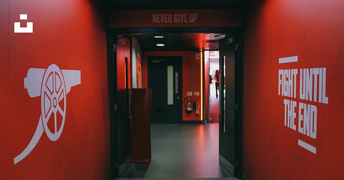 A hallway with red walls and white lettering photo – Free Arsenal Image ...
