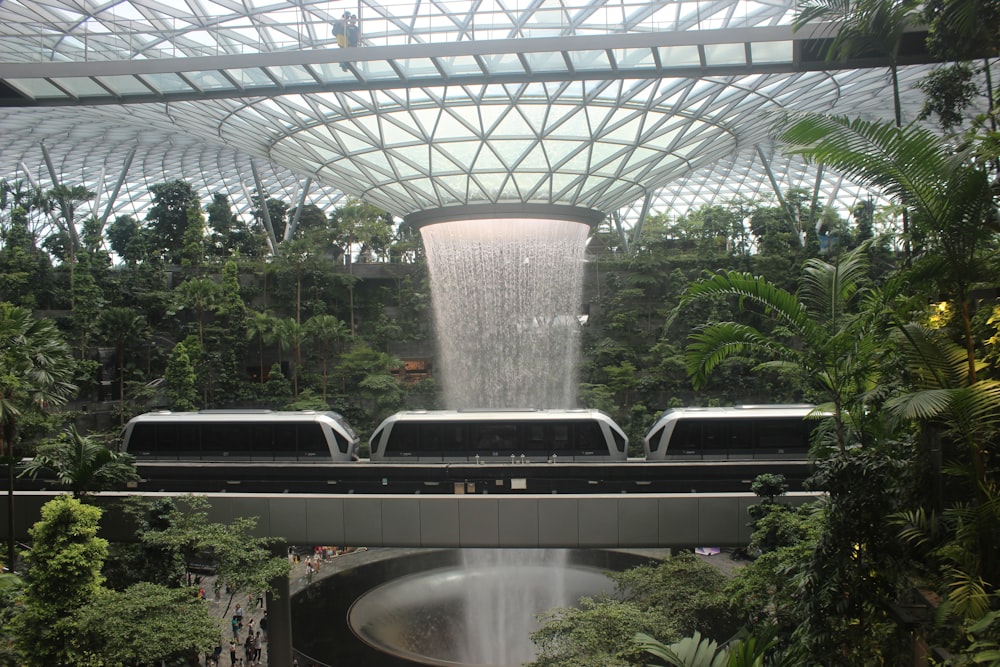 a train station with a waterfall in the middle of it