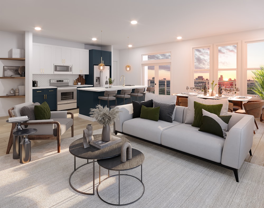 a living room filled with furniture and a kitchen