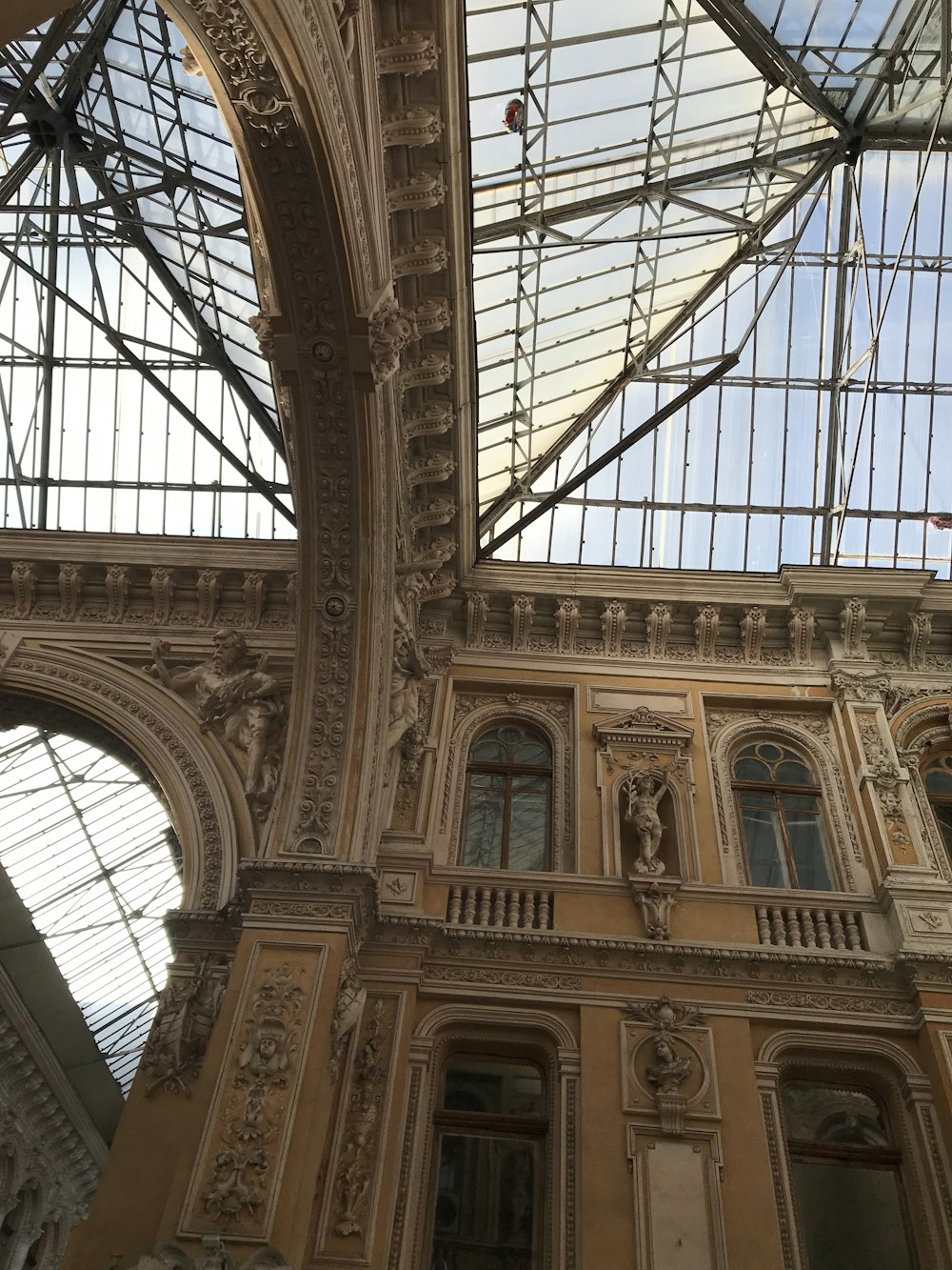 the ceiling of a large building with many windows