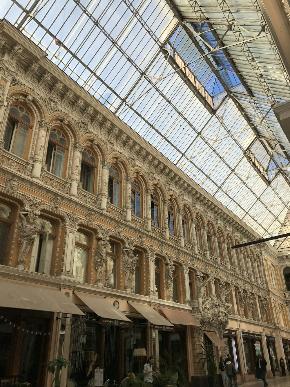 a large building with a glass ceiling and many windows