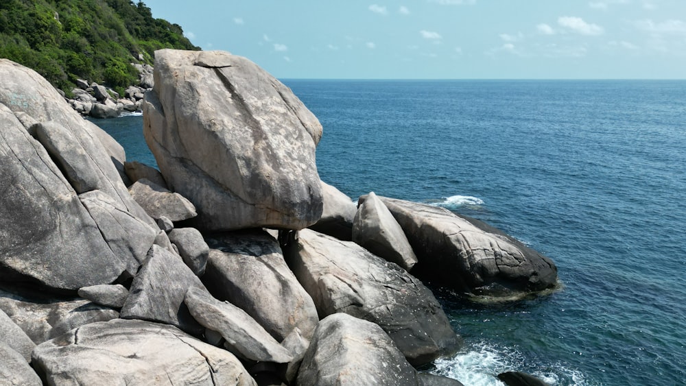 a large rock formation in the middle of a body of water