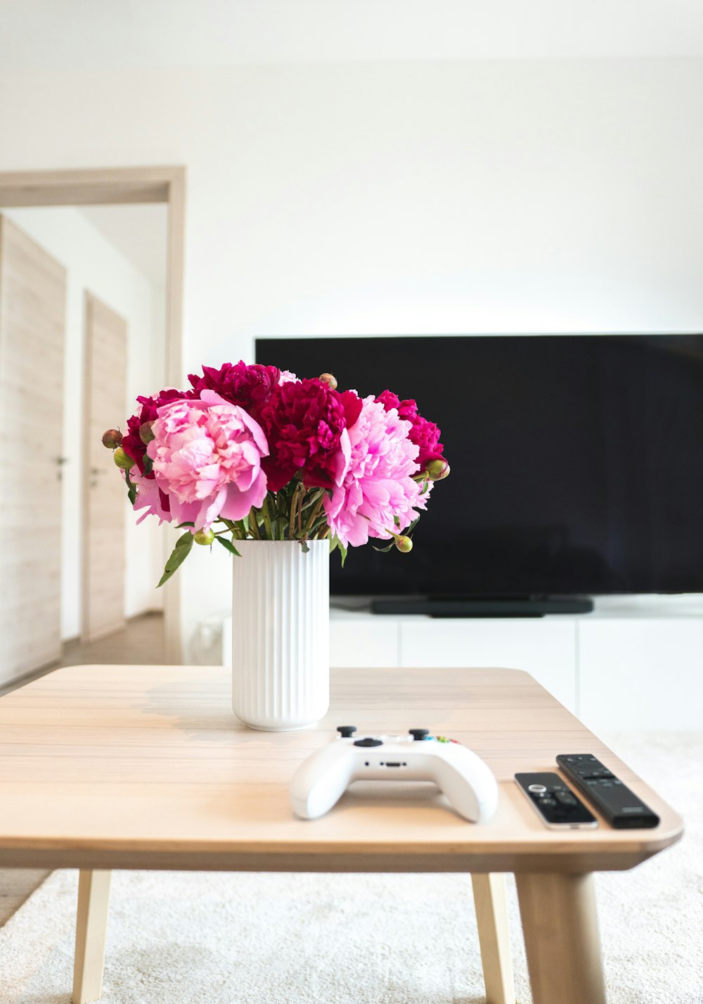 a vase of flowers sitting on a coffee table