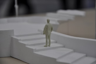 a small figurine standing on a set of stairs
