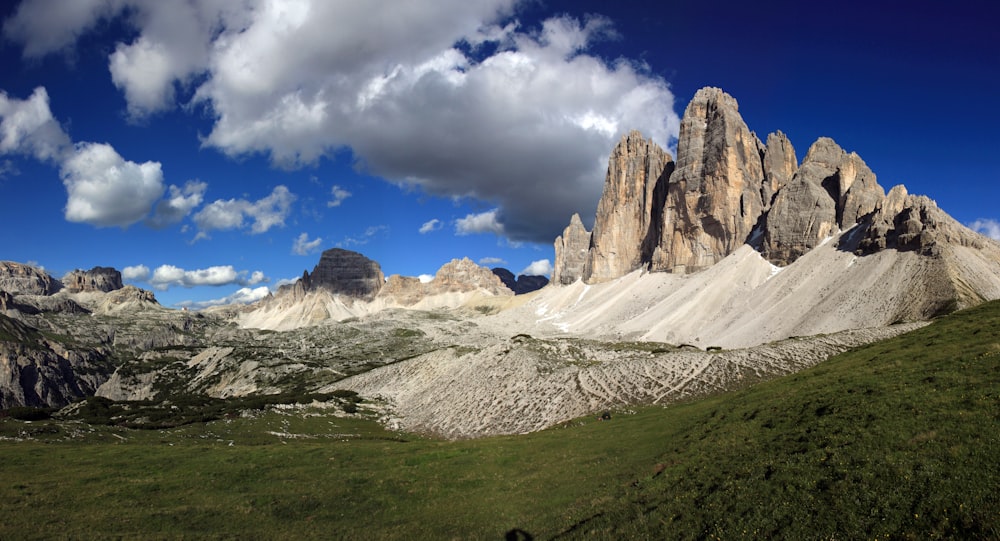 a mountain range with a few clouds in the sky