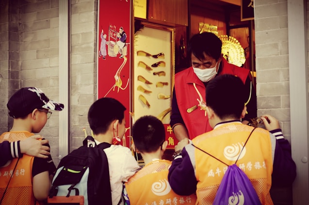 A group of preschool children wearing kidkeep safety vests during a school trip.
