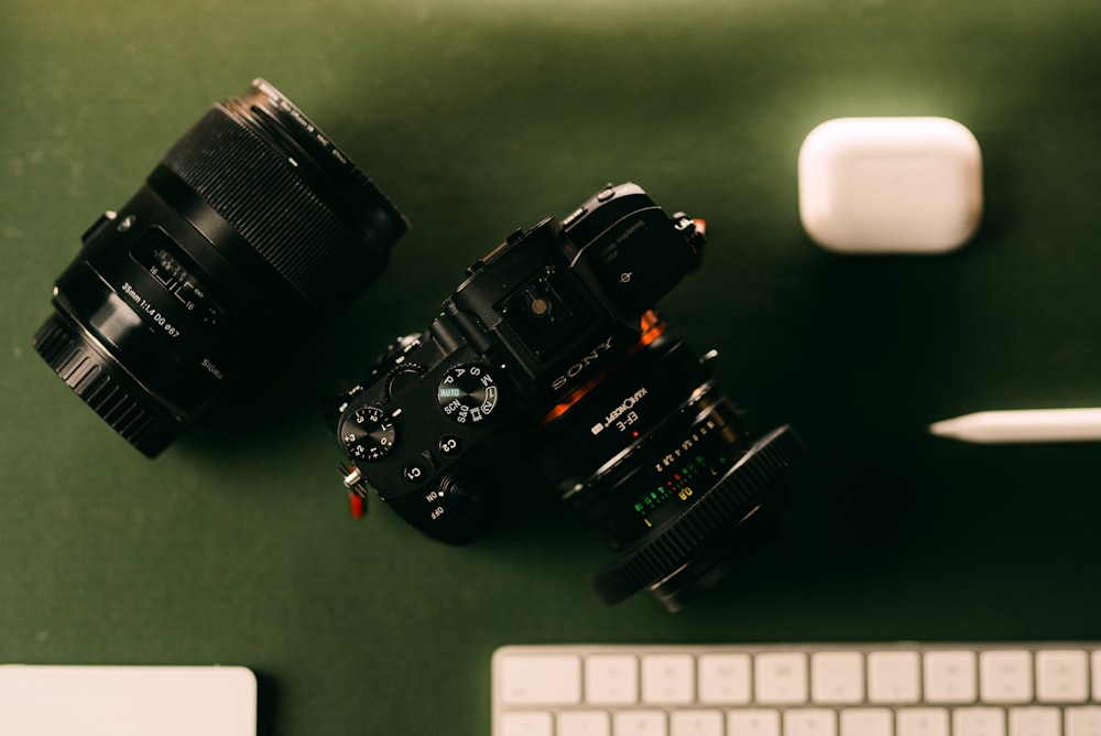 two cameras sitting next to each other on a desk