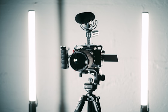 A professional video production setup with cameras and lighting equipment in a studio environment.