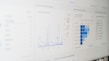 A digital screen displaying analytical data with line graphs, histograms, and numerical values. The data is presented in a user-friendly interface with different shades of blue used to distinguish various elements.