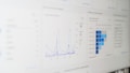 A digital screen displaying analytical data with line graphs, histograms, and numerical values. The data is presented in a user-friendly interface with different shades of blue used to distinguish various elements.