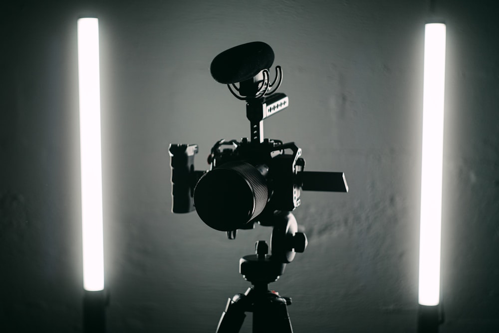 a black and white photo of a camera on a tripod