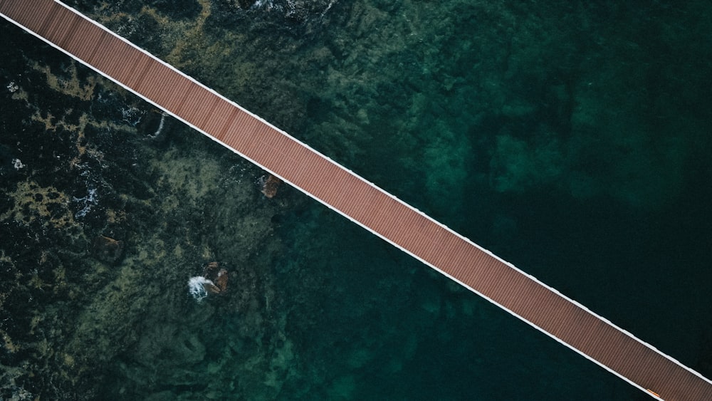 an aerial view of a bridge over a body of water