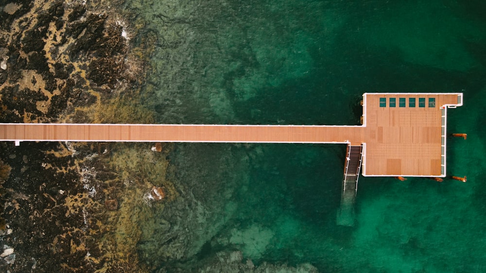 an aerial view of a pier in the ocean